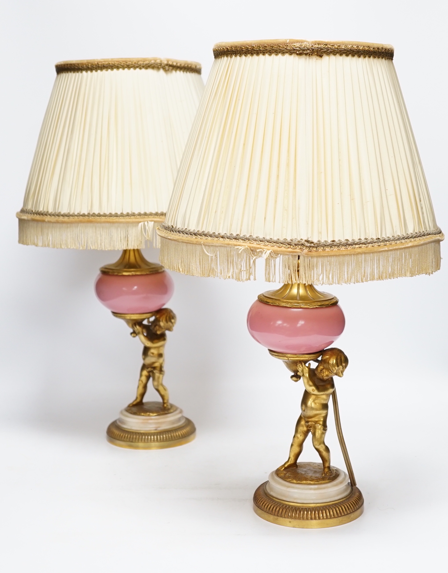 A pair of early 20th century French ormolu and porcelain cherubic lamps, one signed L. Kley, 48cm including shade